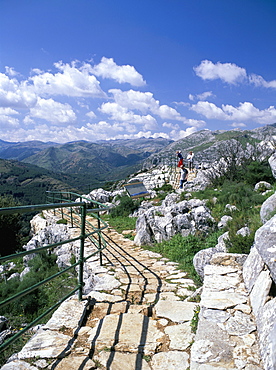 Viewpoint with people admiring view and the limestone Sierra Hidalga in distance, Sierra de las Nieves Natural Park, El Burgo, Malaga, Andalucia (Andalusia), Spain, Europe