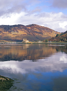 Eilean Donan castle reflected in calm water of Loch Duich from Totaig, Dornie, Highland region, Scotland, United Kingdom, Europe