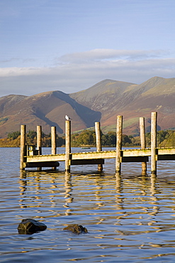 Wooden jetty at Barrow Bay landing on Derwent Water looking north to Skiddaw in autumn, Keswick, Lake District National Park, Cumbria, England, United Kingdom, Europe