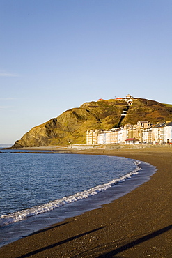 Victorian seafront buildings overlooking empty beach with funicular cliff railway on Constitution Hill in winter light, Aberystwyth, Ceredigion, Dyfed, mid Wales, United Kingdom, Europe