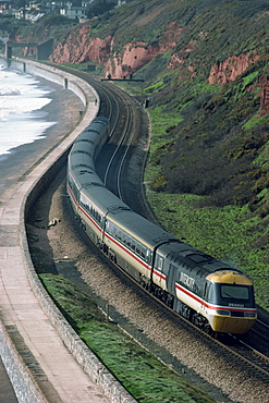 Aerial view over the H.S.125 Intercity train, westbound along coast near Langstone Rock, Devon, England, United Kingdom, Europe