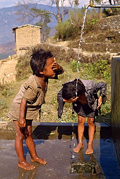 Portrait of two children washing at the school funded by Save the Children, at Chataura, Nepal, Asia