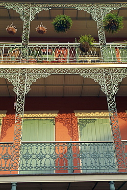 Detail of wrought iron and wooden shutters on balconies of buildings in the French Quarter of New Orleans, Louisiana, United States of America, North America