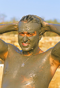 Man putting on mud at the Dead Sea, Jordan, Middle East