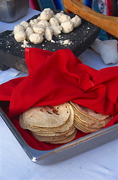 Close-up of tortillas in a tray covered by a red cloth, in Mexico, North America