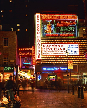 The Raymond Revuebar with neon signs in red light area at night, Soho, London, England, United Kingdom, Europe