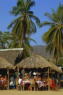 Tourists at a cafe on the beach at Acapulco, Mexico, North America