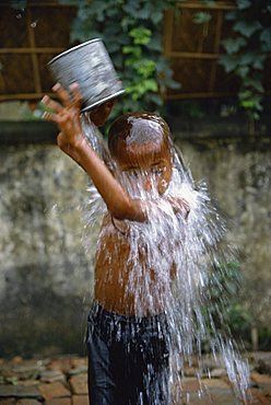 Boy bathing in a slum area, Dhaka, Bangladesh, Asia