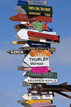 Signs with mileage to world destinations made into a totem pole, Port Stanley, Falkland Islands, South America