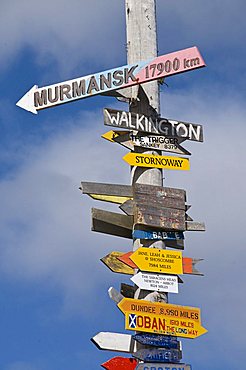 Signs with mileage to world destinations made into a totem pole, Port Stanley, Falkland Islands, South America