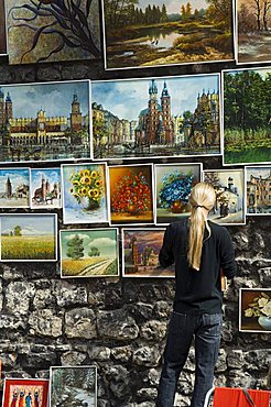 Paintings displayed on the old city walls near Florians's Gate, Krakow (Cracow), Poland, Europe