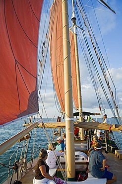 Red sails on sailboat that takes tourists out for sunset cruise, Key West, Florida, United States of America, North America