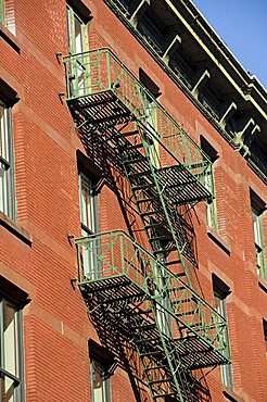 Fire escapes on the outside of buildings in Spring Street, Soho, Manhattan, New York City, New York, United States of America, North America