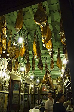 Tapas bar and restaurant with hams hanging from the ceiling, Santa Cruz district, Seville, Andalusia, Spain, Europe