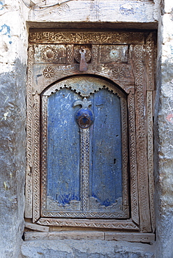 Close-up of a blue door in a carved wood frame in the old city area of the Babylonian town of Sana (the capital of north Yemen), Yemen, Middle East