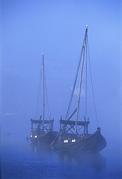 Two port wine barges in the mist on the River Douro in Oporto (Porto), Portugal, Europe