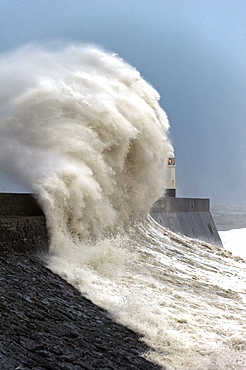 Huge waves crash against the harbour wall at Porthcawl, Bridgend, Wales, United Kingdom, Europe