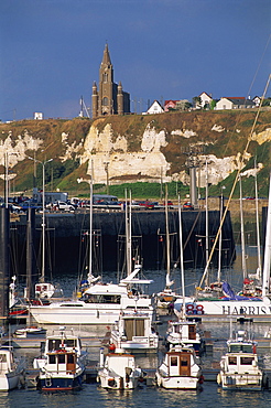 Boats and yachts in the harbour and church on skyline above cliffs, Dieppe, Haute Normandie (Normandy), France, Europe