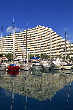 Reflection of boats and modern apartment block in the water of the Marina in the Baie des Anges, in Provence, France, Europe