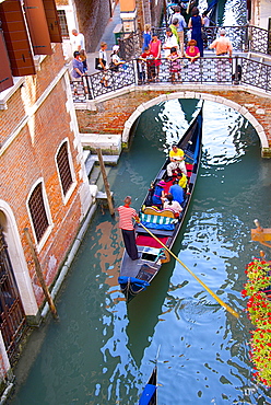 Gondola with tourists on canal under a bridge, Venice, UNESCO World Heritage Site, Veneto, Italy, Europe