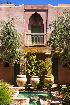 Typical Moroccan architecture, riad adobe walls, fountain and flower pots, Morocco, North Africa, Africa