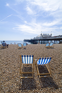 Deck chairs and pier, Brighton Beach, Brighton, Sussex, England, United Kingdom, Europe