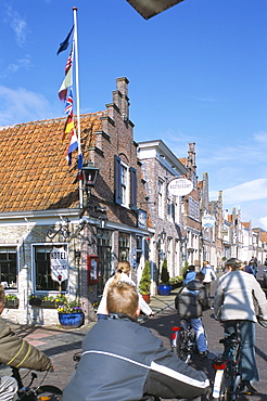 Children cycling by Fortuna Hotel, Edam, The Netherlands (Holland), Europe