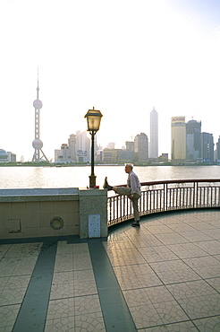 Senior man stretching leg, Shanghai, China, Asia