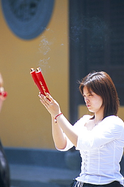 Young woman praying, Shanghai, China, Asia