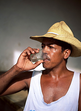 Man drinking a rum after work, Trinidad, Cuba, West Indies, Central America