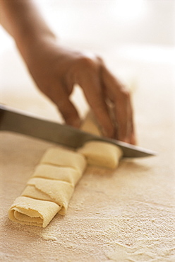 Cutting uncooked pasta into parcel shapes, Arezzo, Tuscany, Italy, Europe