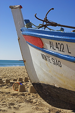 Traditional fishing boat and sand castles, Fishermans Beach, Albufeira, Algarve, Portugal, Europe