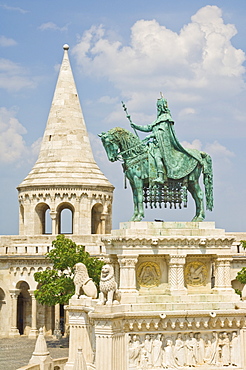 Equestrian statue of King Stephen with the towers and conical turrets of the neo-romanesque Fishermen's Bastion, built by Frigyes Schulek in 1895, Budapest, Hungary, Europe