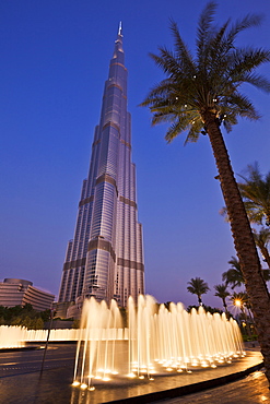 Burj Khalifa and entrance fountains and palm tree at night, Dubai City, United Arab Emirates, Middle East