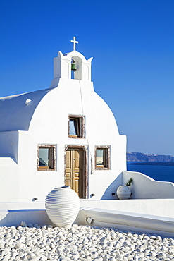 White church of Agios Vasilios overlooking Aegean Sea, Oia, Santorini (Thira), Cyclades Islands, Greek Islands, Greece, Europe