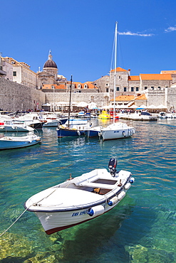 Fishing boat and clear water in the Old Port, Dubrovnik Old Town, Dalmatian Coast, Dubrovnik, Croatia, EU, Europe