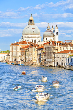 Vaporettos (water taxis) passing the grand church of Santa Maria della Salute, on the Grand Canal, Venice, UNESCO World Heritage Site, Veneto, Italy, Europe