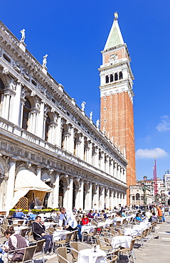 Campanile tower, Piazzetta, and tourists enjoying the cafes of St. Marks Square, Venice, UNESCO World Heritage Site, Veneto, Italy, Europe