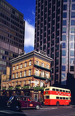 Double-decker bus and taxi crossing junction in Victoria, London