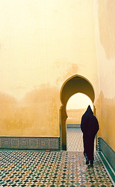 Hooded figure visiting the Tomb of Moulay Ismail, Meknes