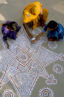 Women painting a mandana on the ground, village near Jodhpur, Rajasthan state, India, Asia