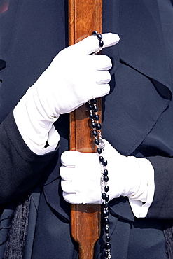 Gloved hands with rosary, Holy Week, Cagliari, Sardinia, Italy, Europe