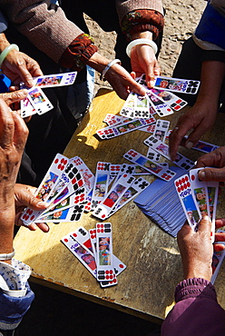 Naxi women playing a local game of cards, Lijiang, Yunnan, China, Asia 