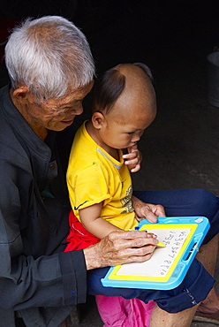 Grandfather and  child, Dong village of Zhaoxing, Guizhou Province, China, Asia