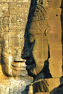 Stone heads typifying Cambodia on the Bayon Temple at Angkor Wat, Siem Reap, Cambodia, Asia. 