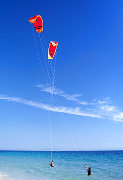 Two kiteboarders trying to take off, Tarifa, Costa de la Luz, Cadiz Province, Andalucia (Andalusia), Spain. Europe