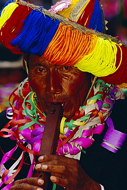 Portrait of a man playing typical instrument, wooden flute, Oruro's carnival, the Devil dance (La Diablada), Oruro, Bolivia, South America