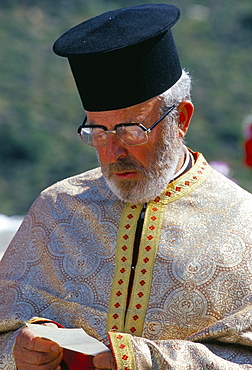 Portrait of a Greek Orthodox priest praying during Lambri Triti festival, Olymbos (Olimbos), Karpathos, Dodecanese islands, Greece, Mediterranean, Euope