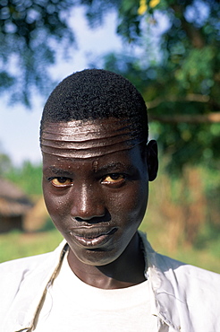 Head and shoulders portrait of a Nuer man with forehead scarification, Itang region, Ilubador state, Ethiopia, Africa