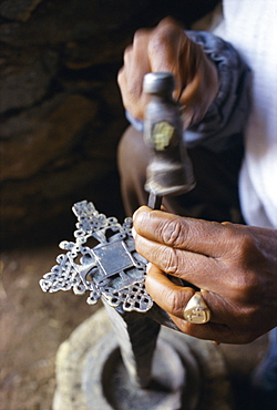 Close-up of blacksmith's hands working on metal cross, Axoum (Axum) (Aksum), Tigre region, Ethiopia, Africa